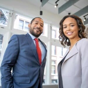 man and woman smiling inside building 1367269