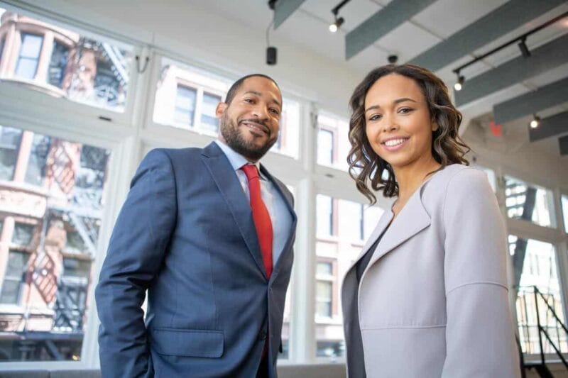 man and woman smiling inside building 1367269